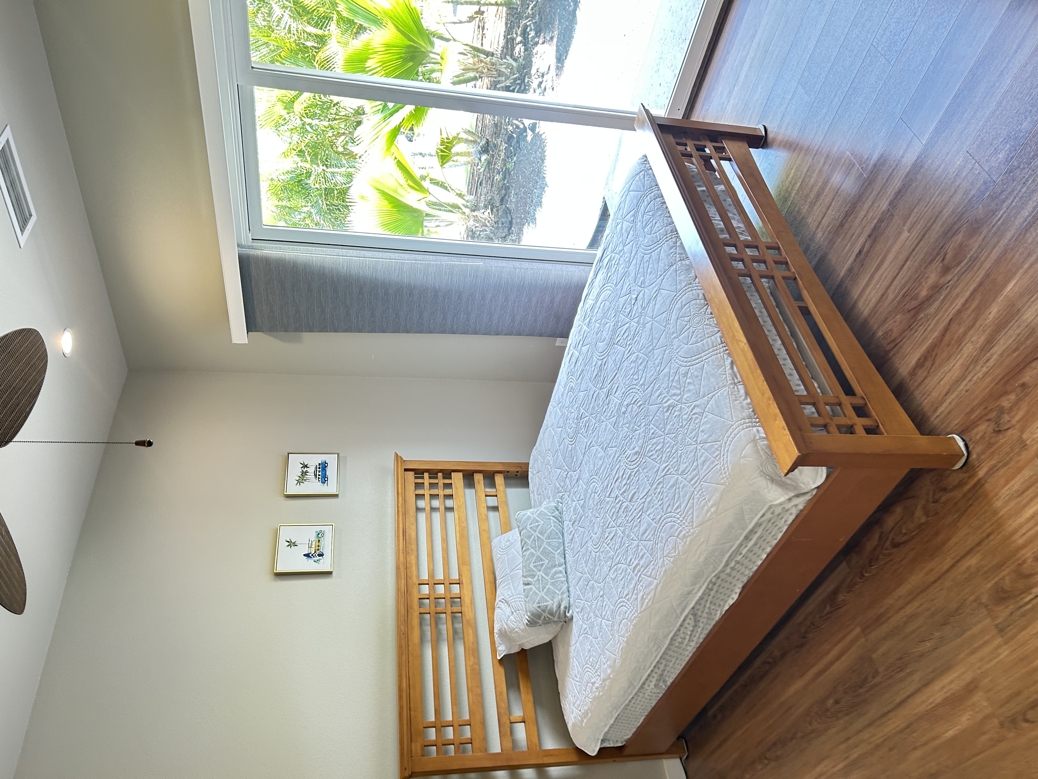 Fourth bedroom with queen-size bed and views of tropical greenery